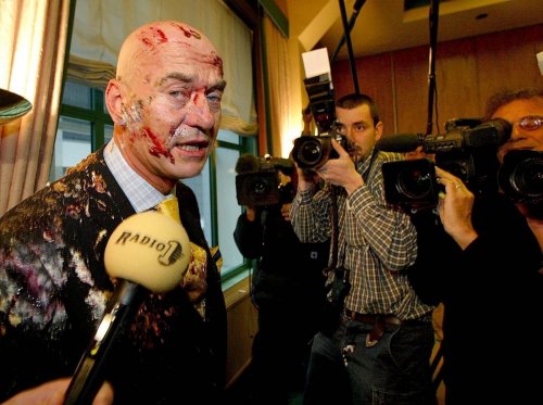 Fortuyn with cake dumped in his face by a vandal